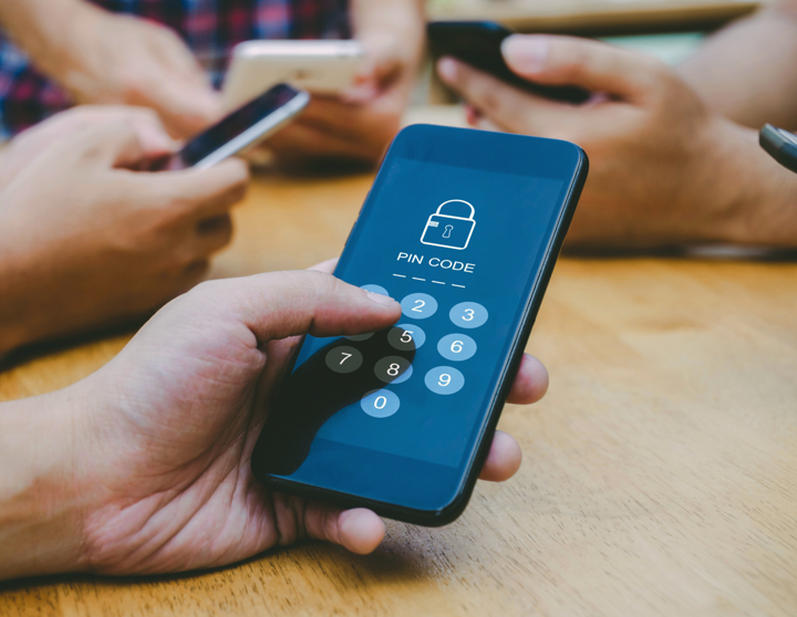 A hand making an online purchase with Strong Customer Authentication on a phone
