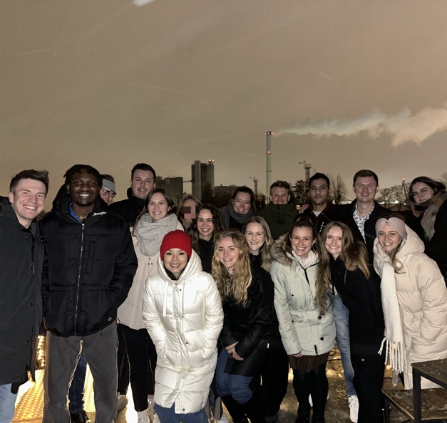 An outdoor group picture of Timothy and 17 other Riverty employees