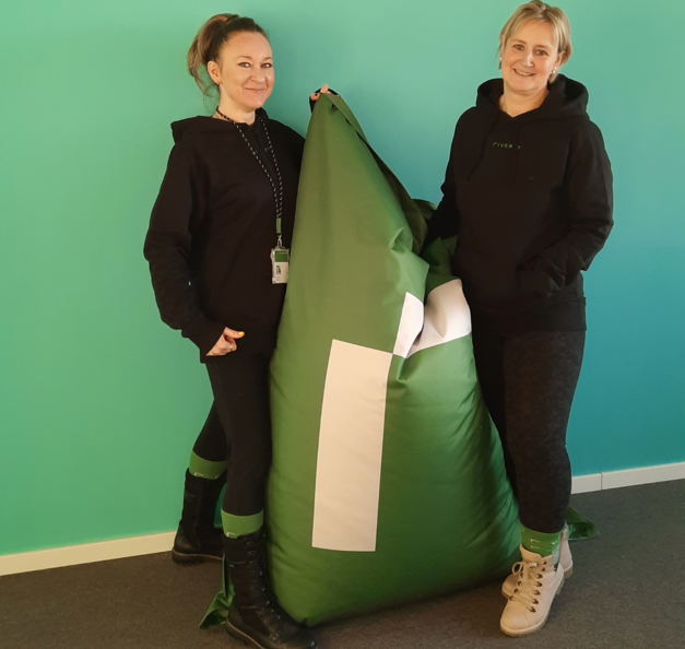 Antonina and her colleague standing next to a Riverty beanbag
