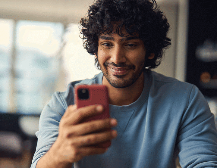 Man smiling at phone