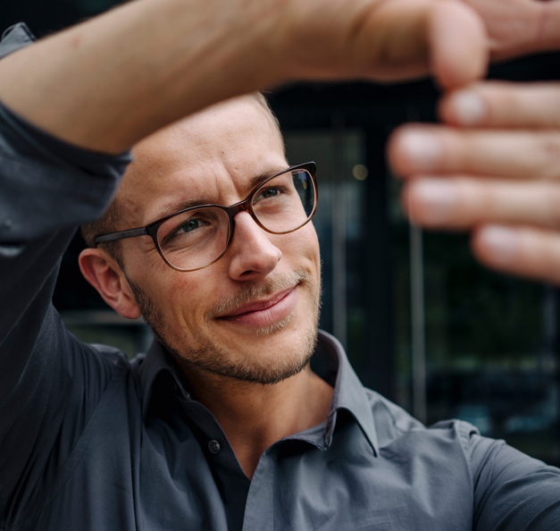 Man holding up his hands and looking at them.